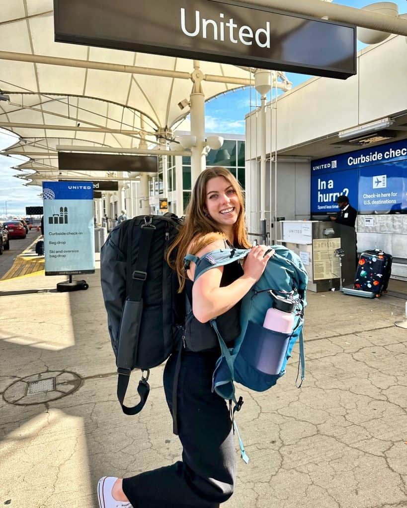 Maddie at the airport with her backpacks