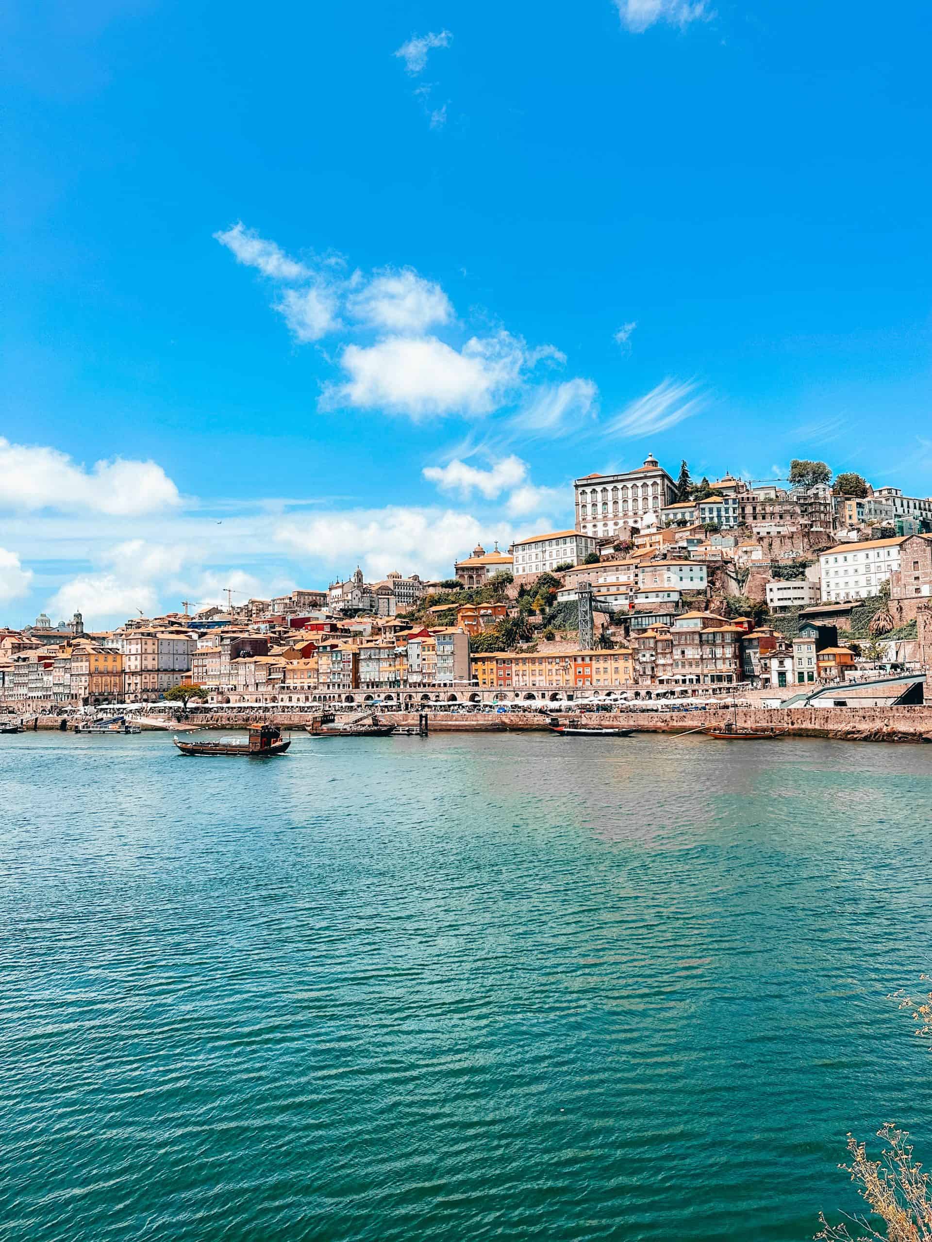 A vibrant view of the Duoro River and Portuguese buildings in Porto, Portugal
