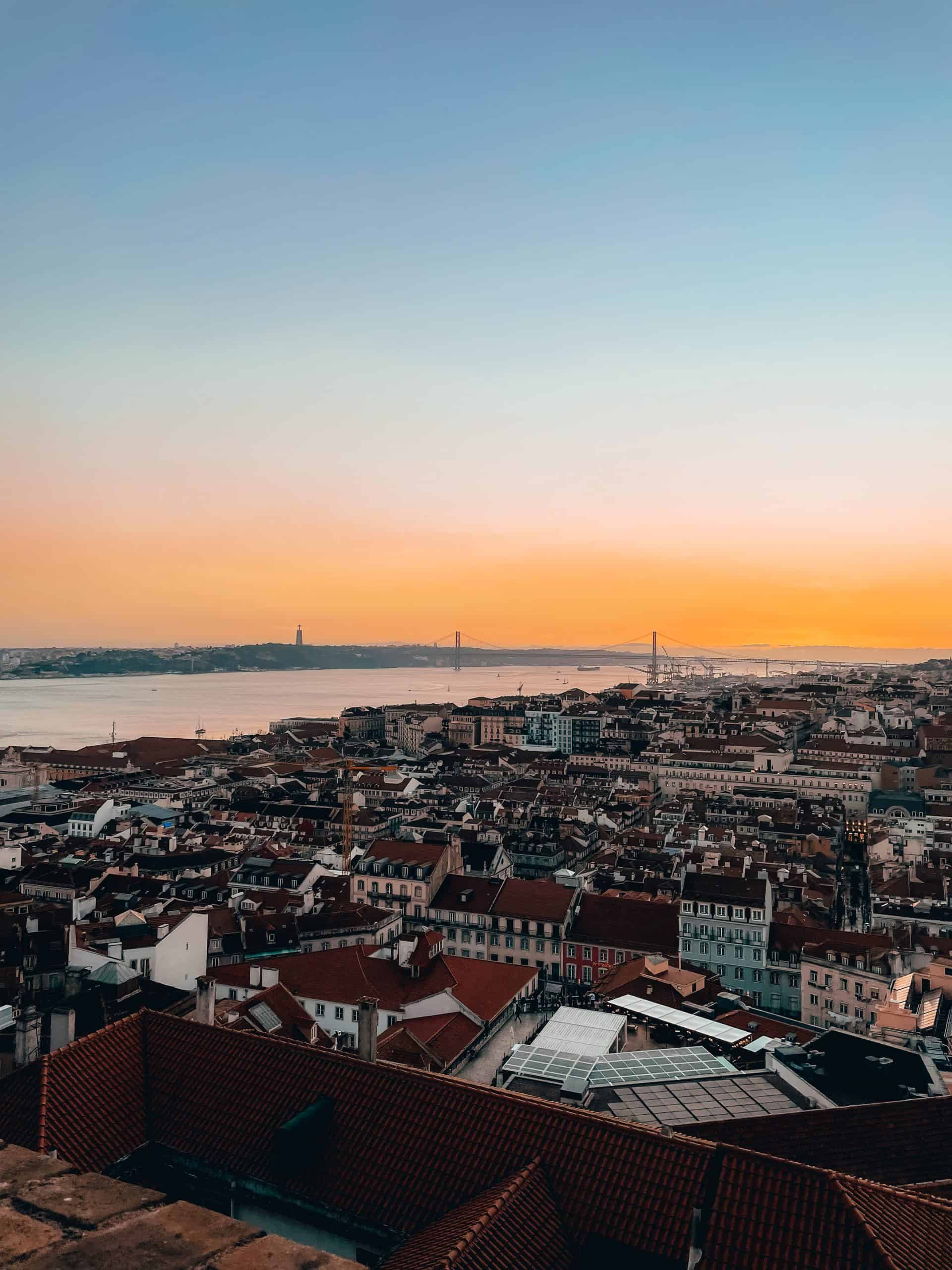 Beautiful orange sunset over Lisbon's cityscape in Portugal