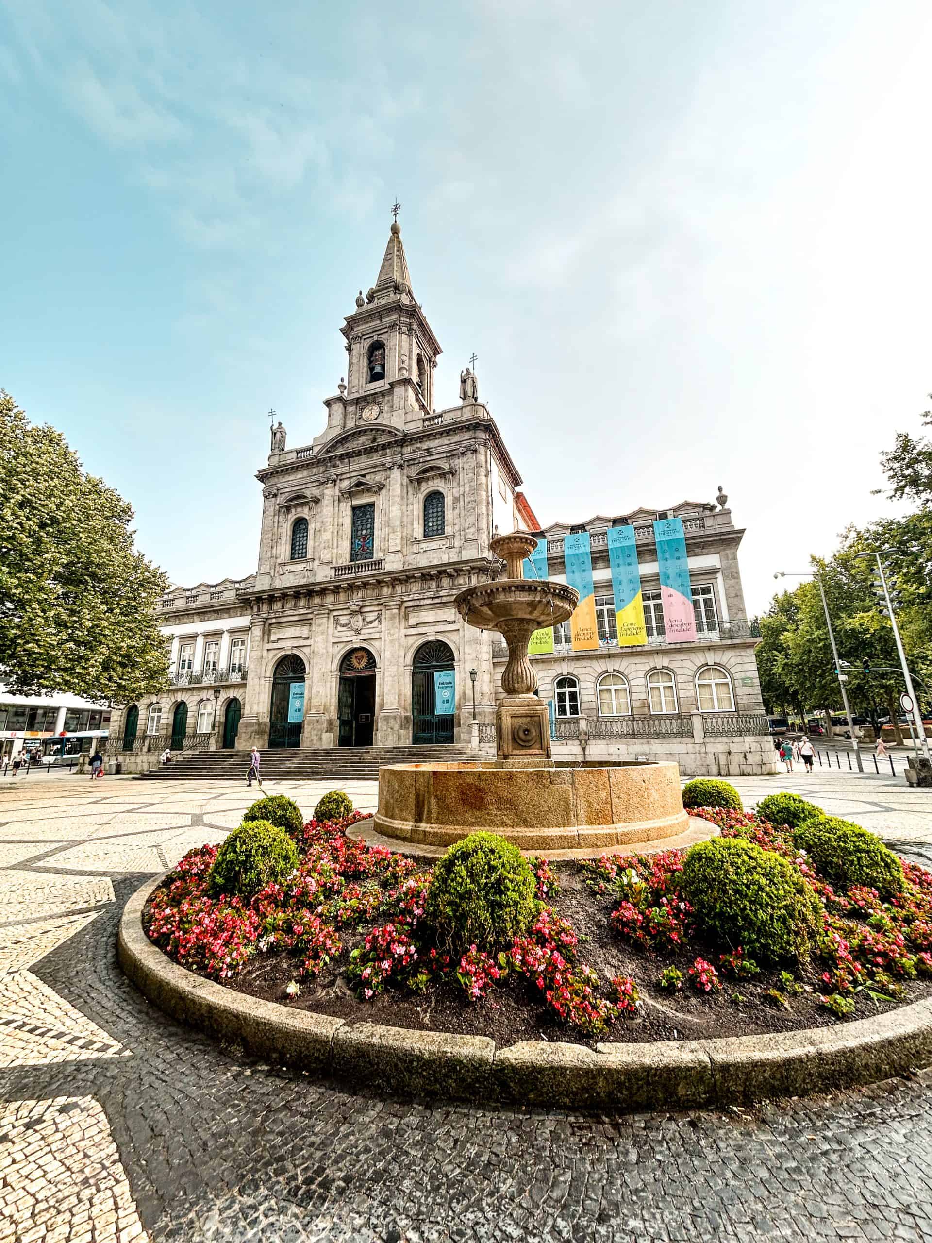 Beautiful, historical architecture with a fountain and flowers on a summer day in Porto, Portugal
