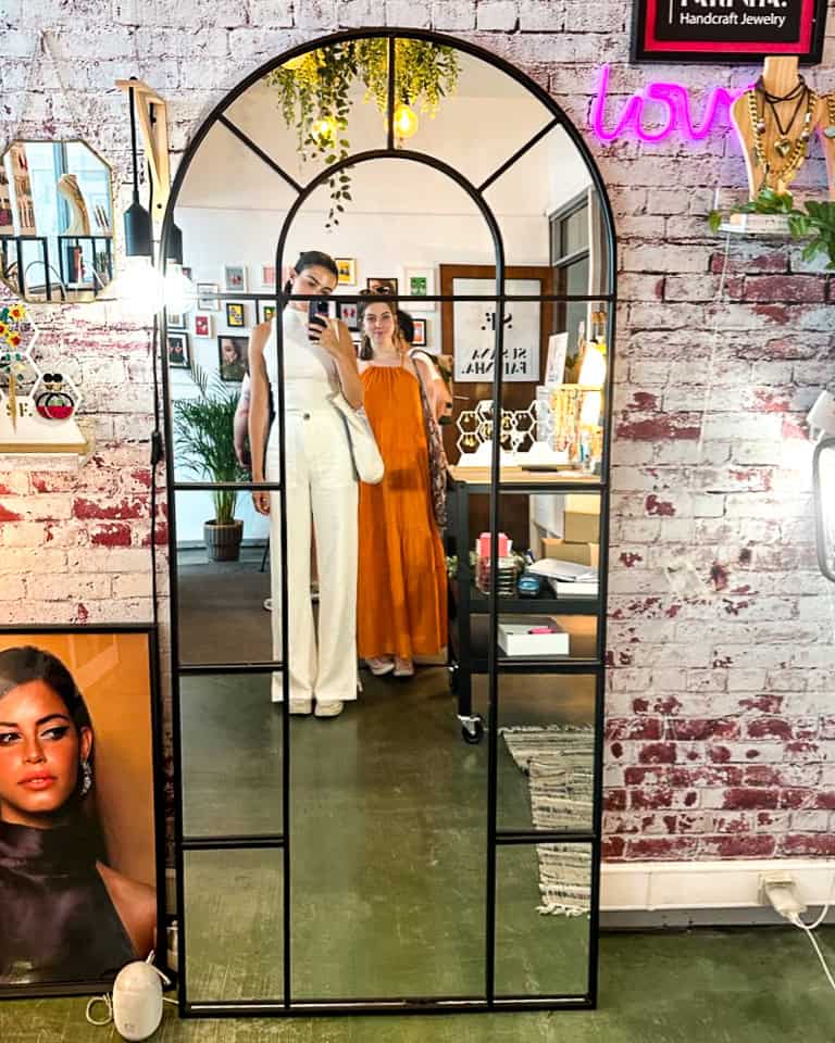 5 Days in Lisbon Two women standing in front of a mirror at an arty store in the LX Factory neighborhood in Lisbon, Portugal