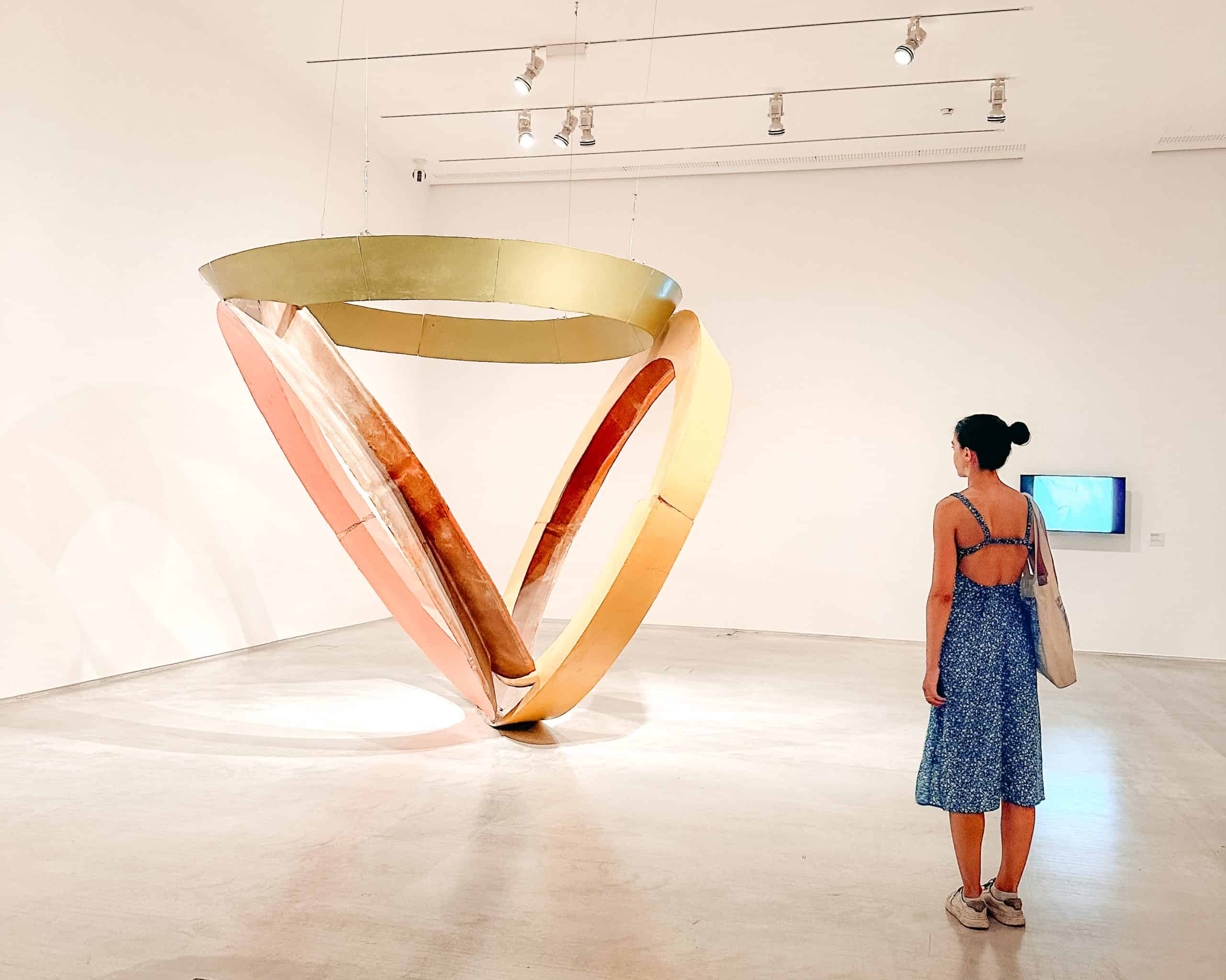 Living in Spain Woman admiring an art sculpture at the Reina Sofía Museum in Madrid, Spain