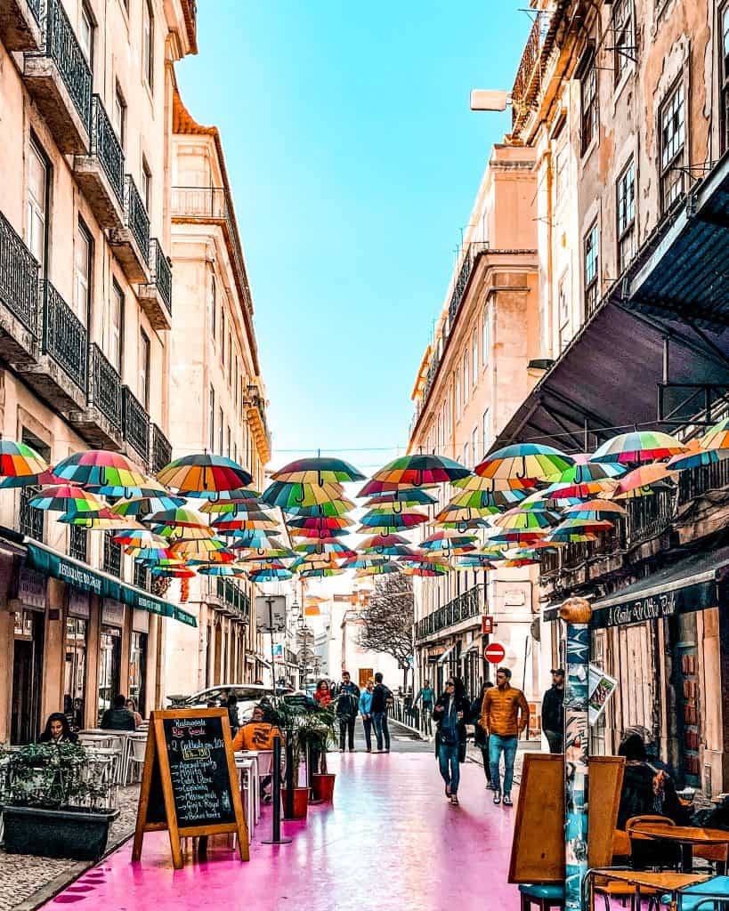 5 Days in Lisbon Rainbow umbrellas above the famous Pink Street in Lisbon, Portugal