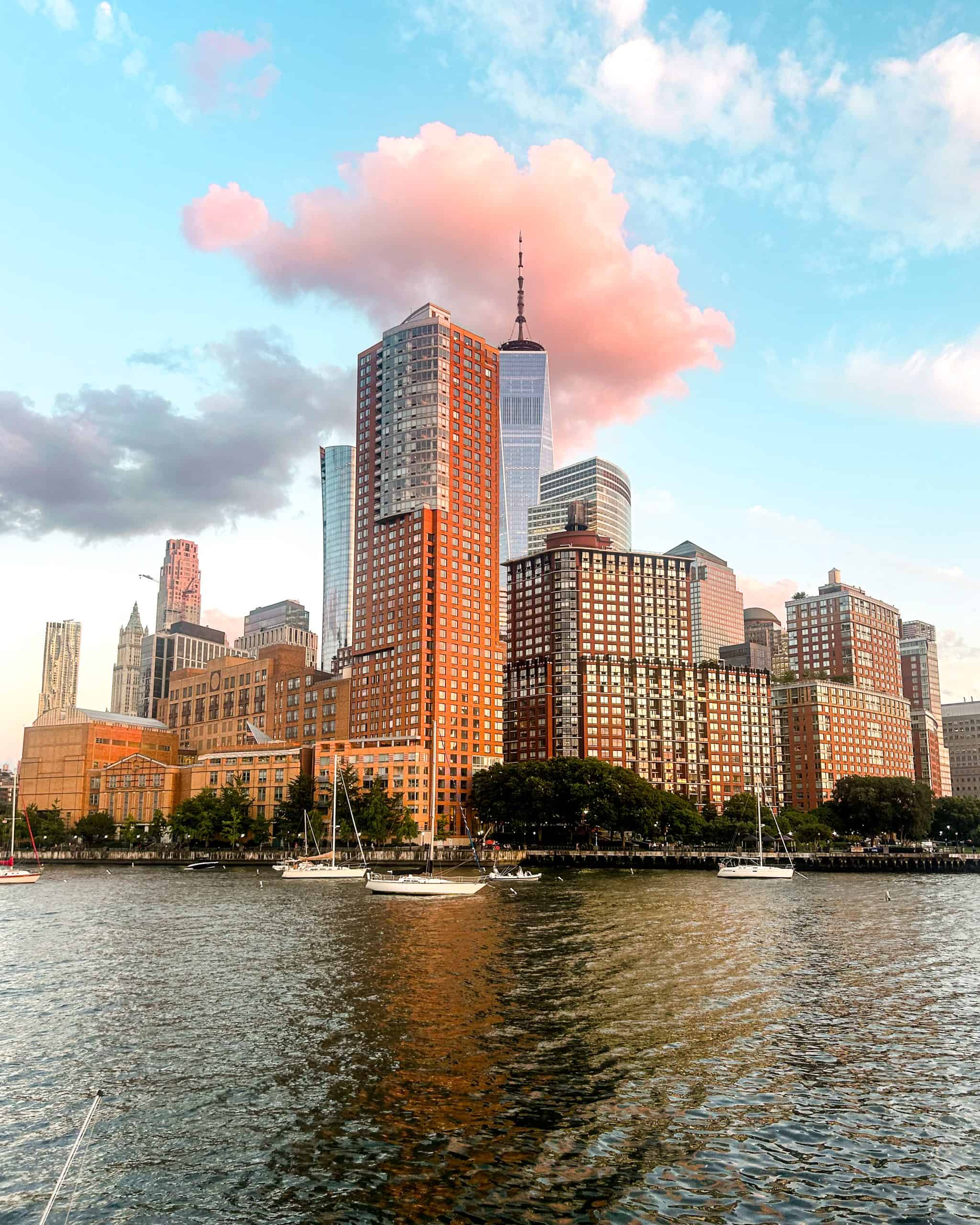 New York City skyline with buildings and sailboats on the Hudson River