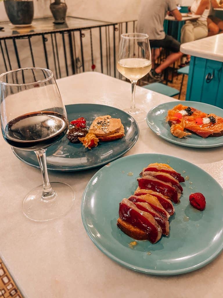 Living in Spain Two glasses of wine and a few plates of appetizers on a table in a restaurant in Madrid, Spain