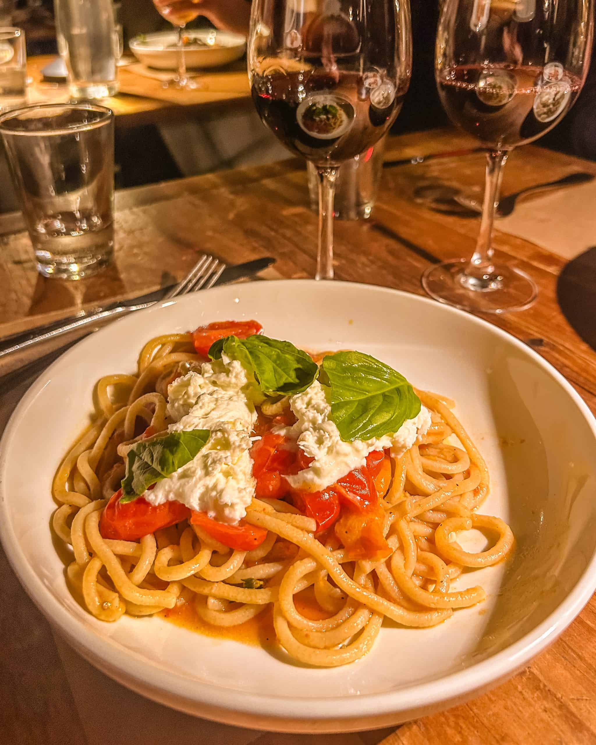 Pasta dish with wine at Emporio, an Italian restaurant in Soho, New York