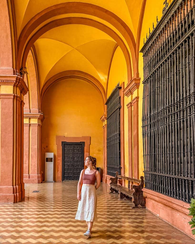 Living in Spain Young woman standing in an extravagant hall at a historical monument in Seville, Spain