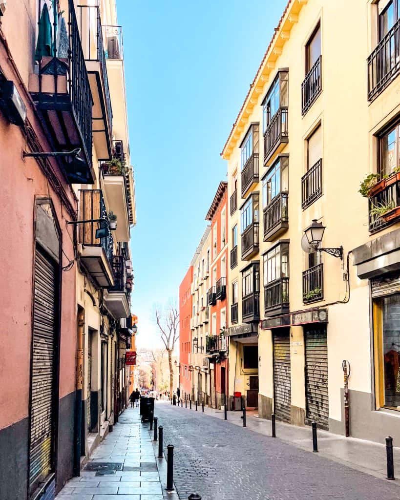 Non-touristy things to do in Madrid Colorful street in Madrid, Spain on a sunny day