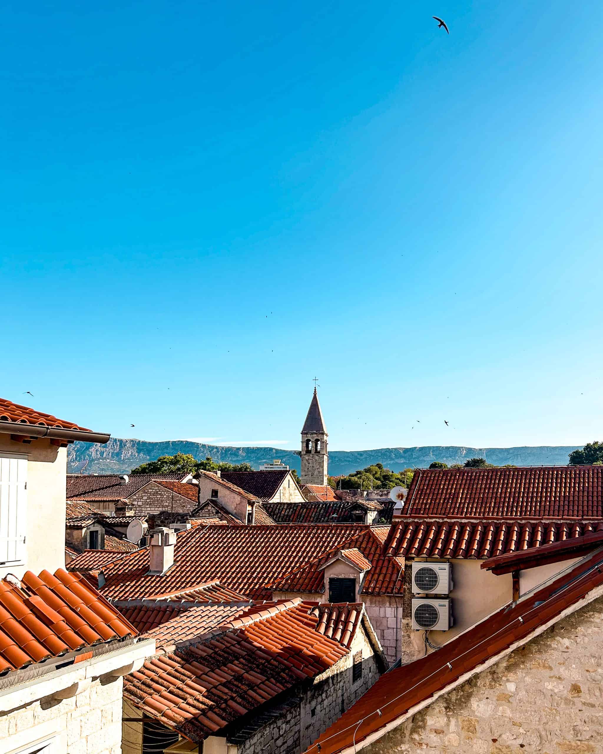 Is Croatia worth visiting? Buildings with red roofs against a blue sky in Split, Croatia