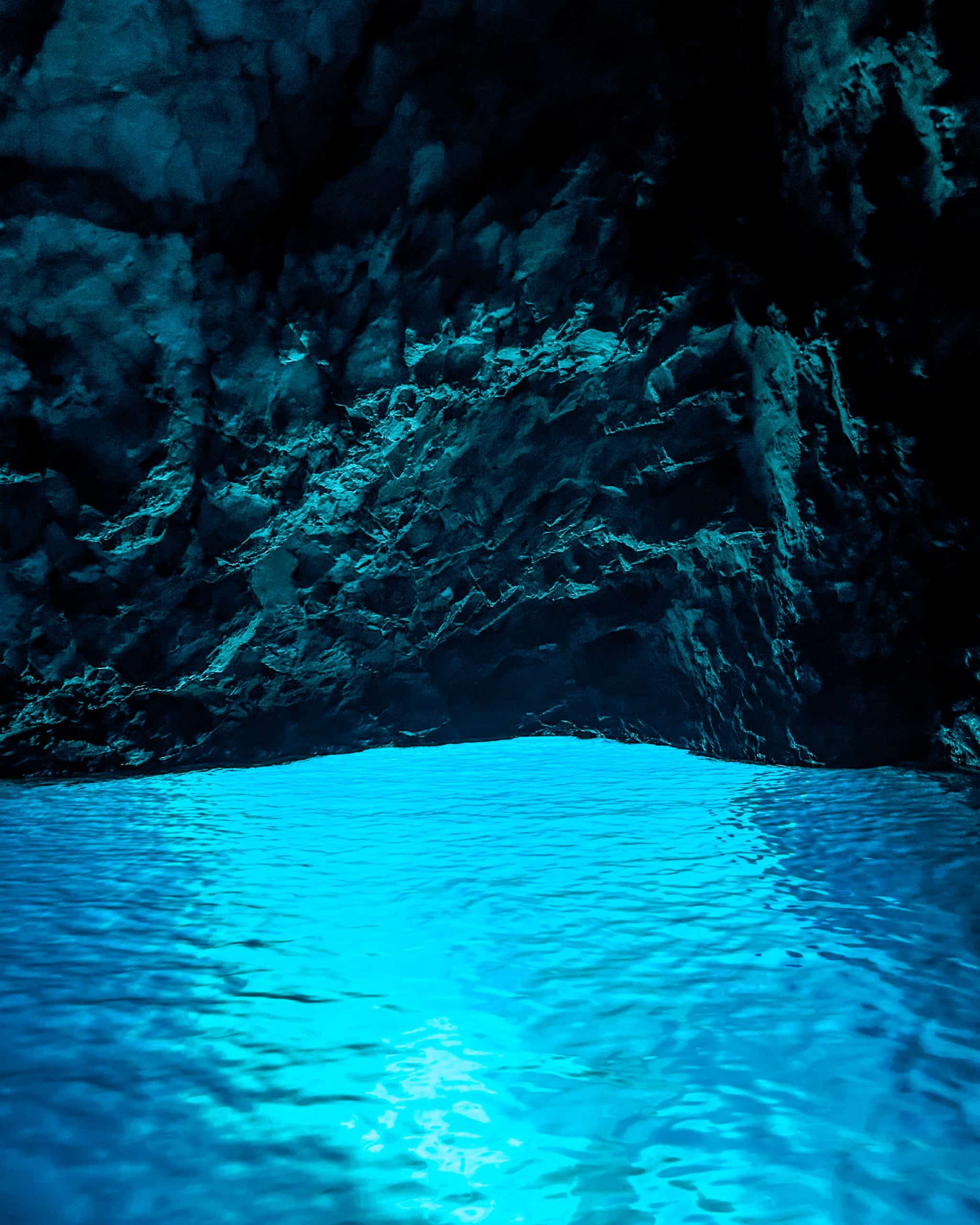 9 days in Croatia glowing blue water against the rocky cave ceiling in the Blue Cave in Croatia