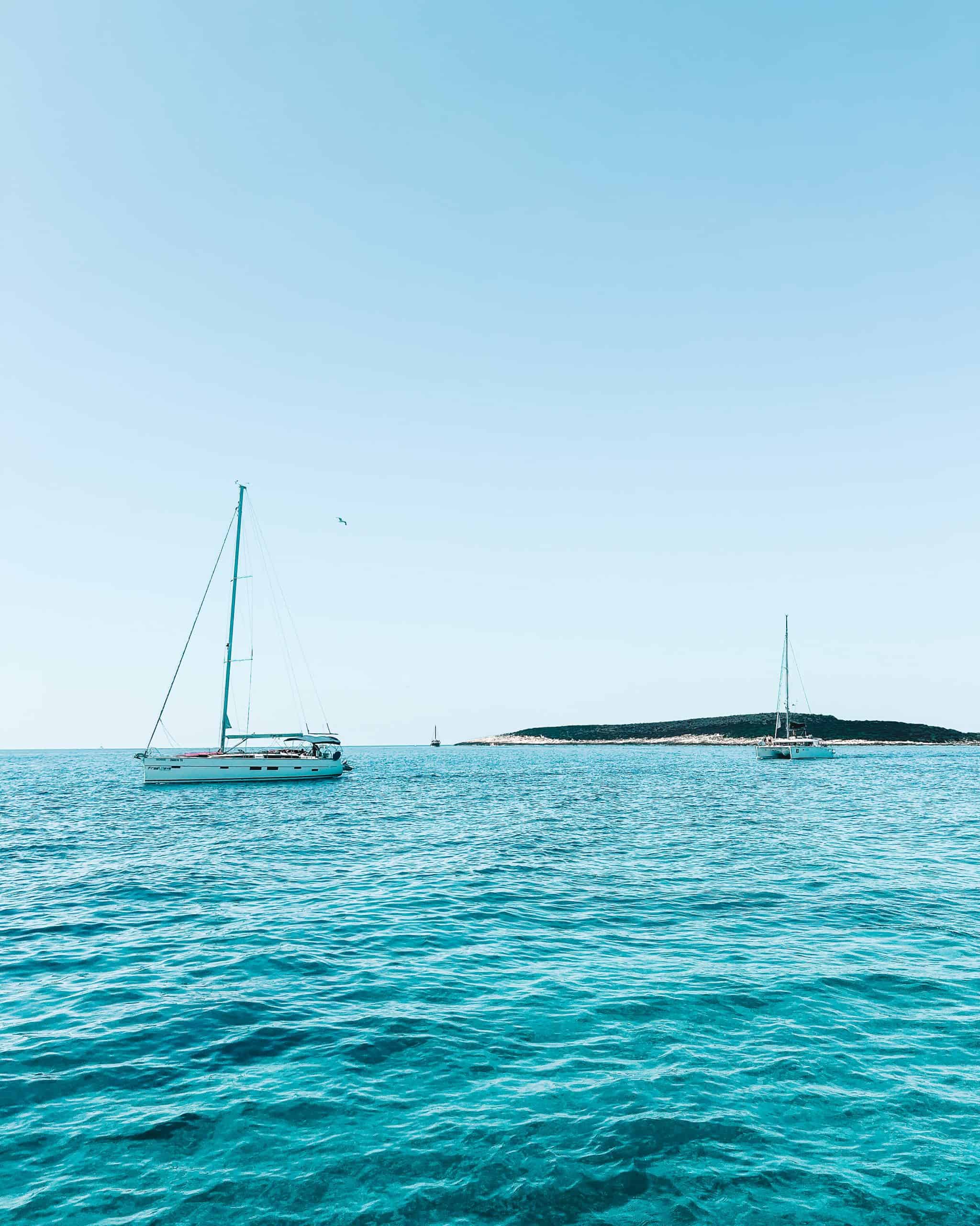 Is Croatia worth visiting? two sailboats on a blue ocean against a blue sky in Croatia
