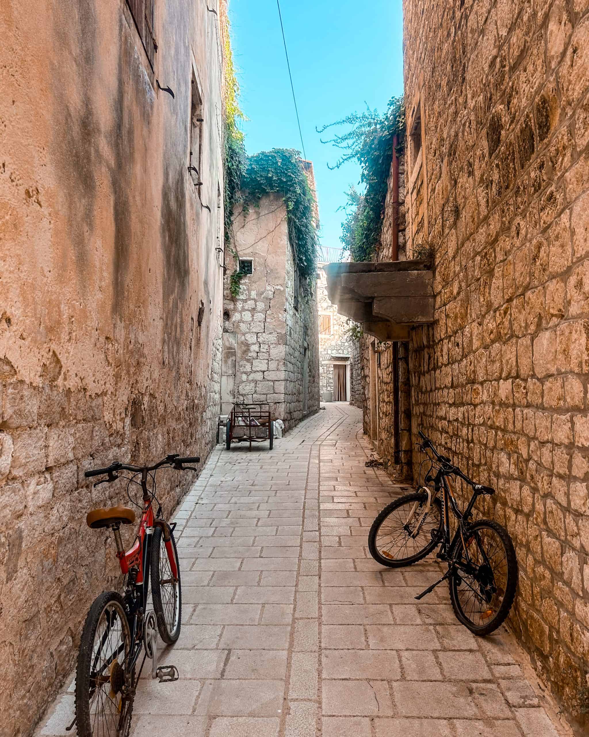 9 days in Croatia Two bikes in a narrow cobblestone alleyway in Hvar, Croatia