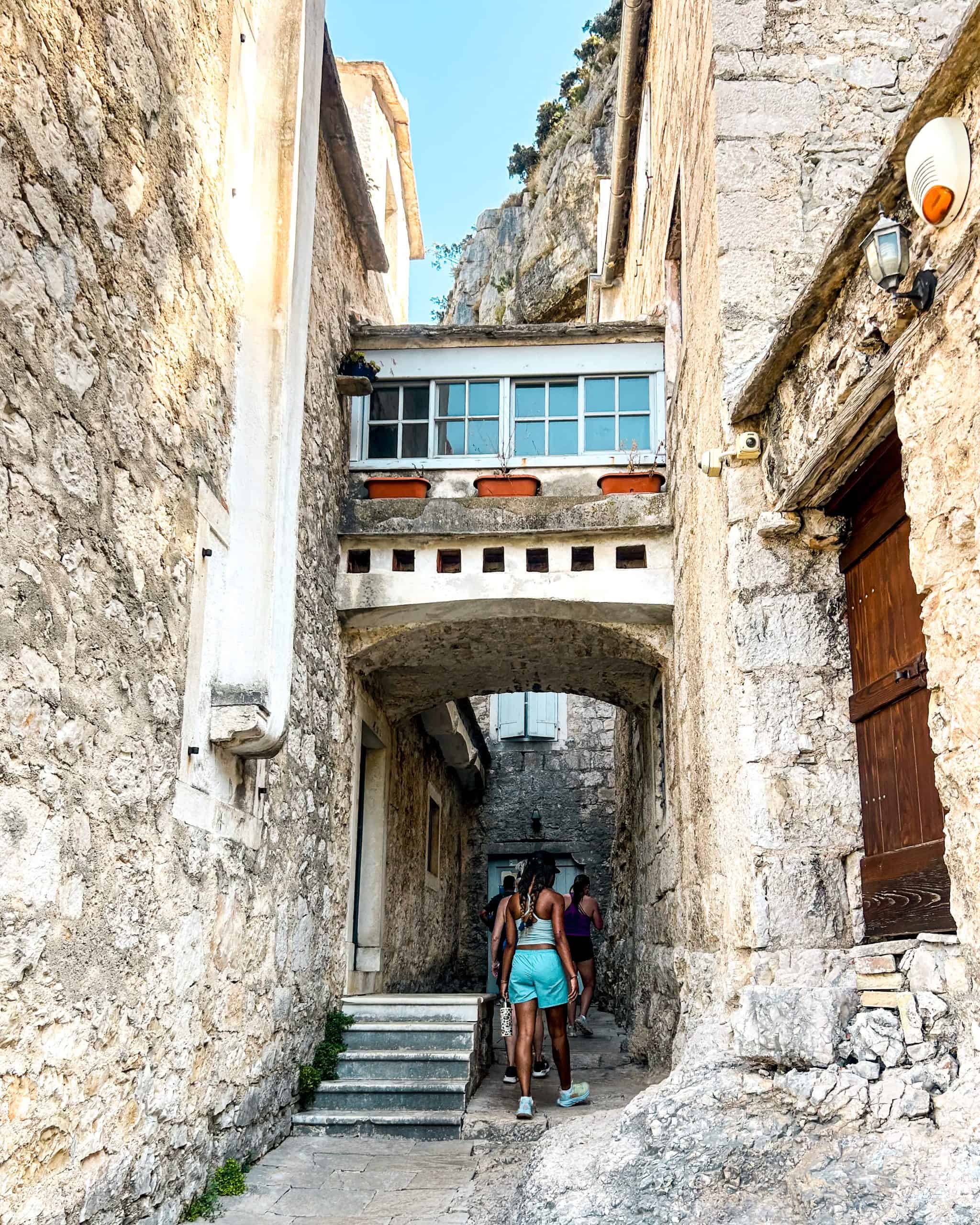 Is Croatia worth visiting? People walking through a historic monastery on an island in Croatia