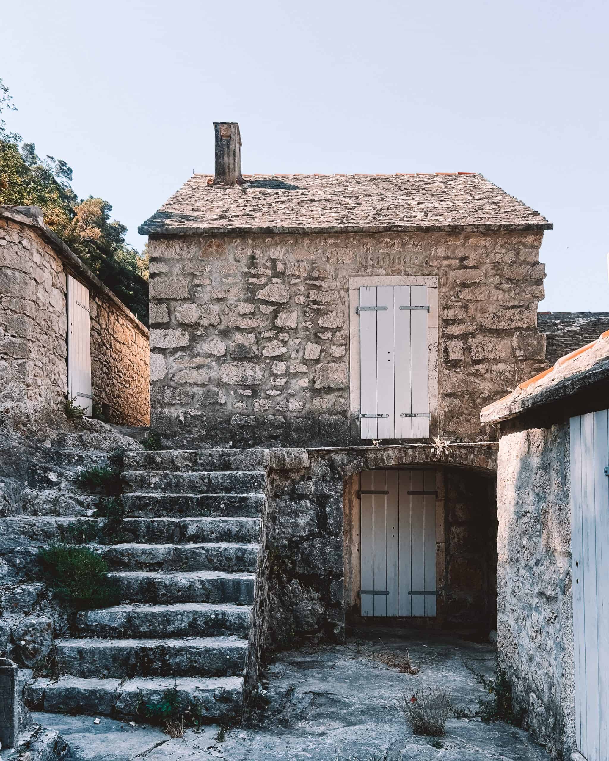 Is Croatia worth visiting? quiet, historic monastery built of wood and stone on an island in Croatia