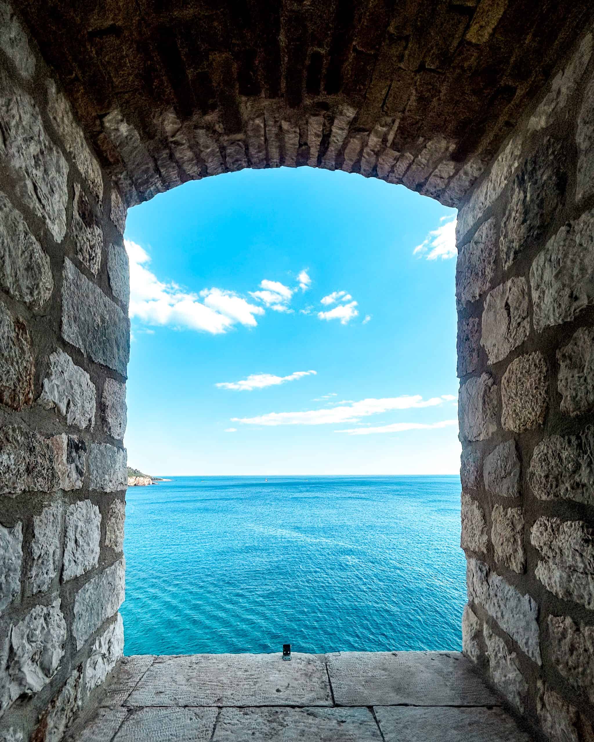 9 days in Croatia A stone archway showing a view of the blue sky and blue sea in Dubrovnik, Croatia