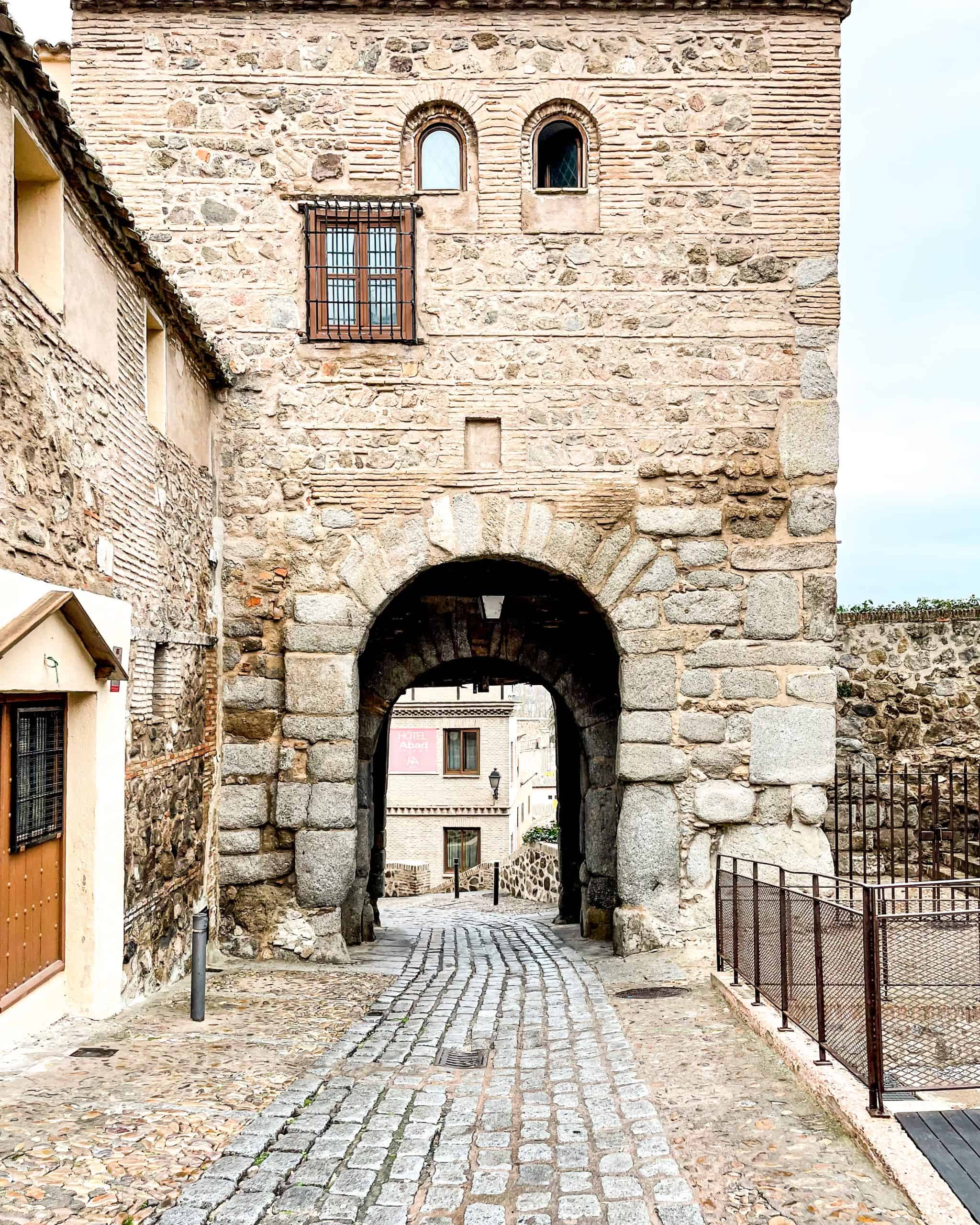 historic stone building featuring an archway in Toledo, Spain