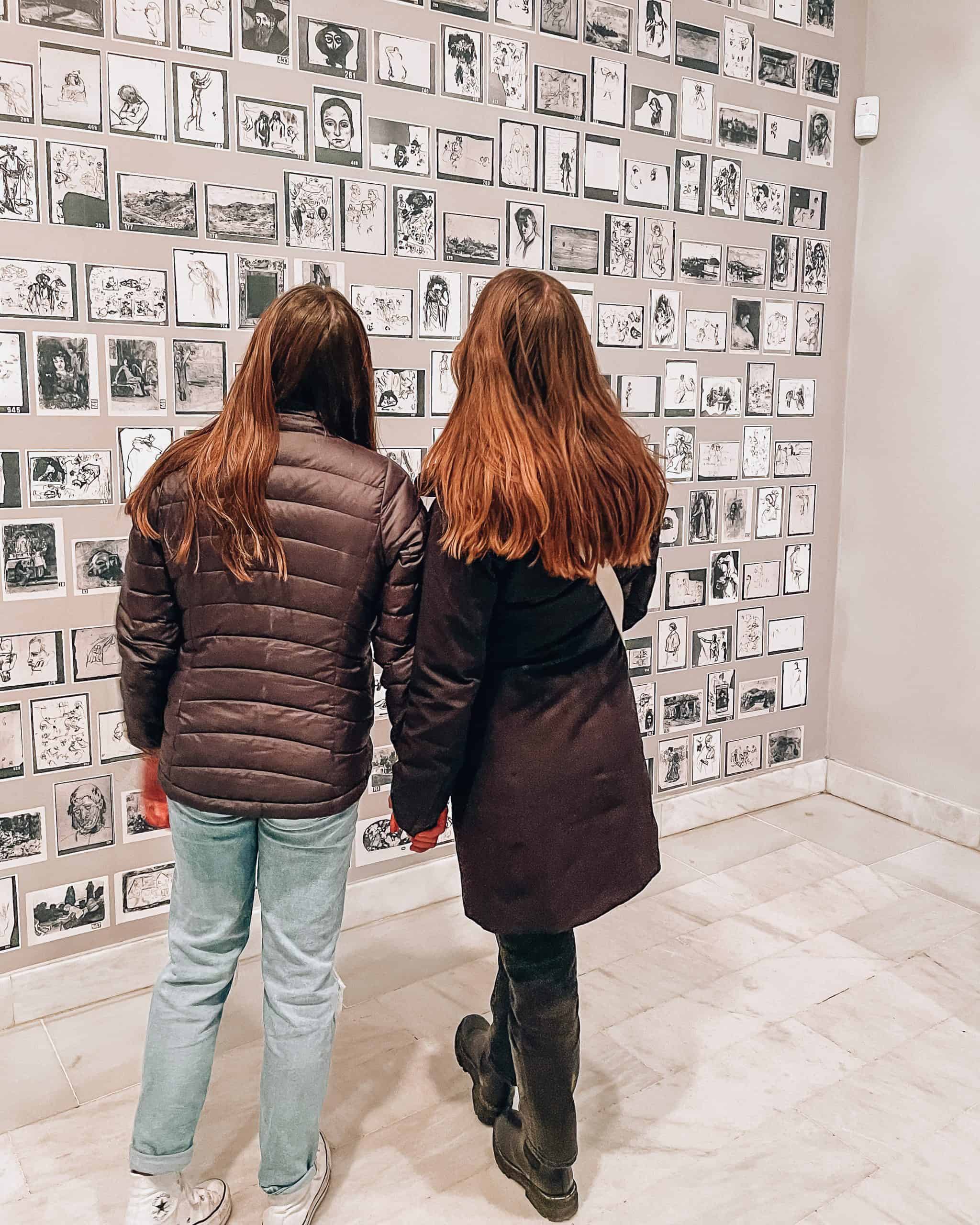 two women staring at the art in the Picasso Museum in Barcelona, Spain