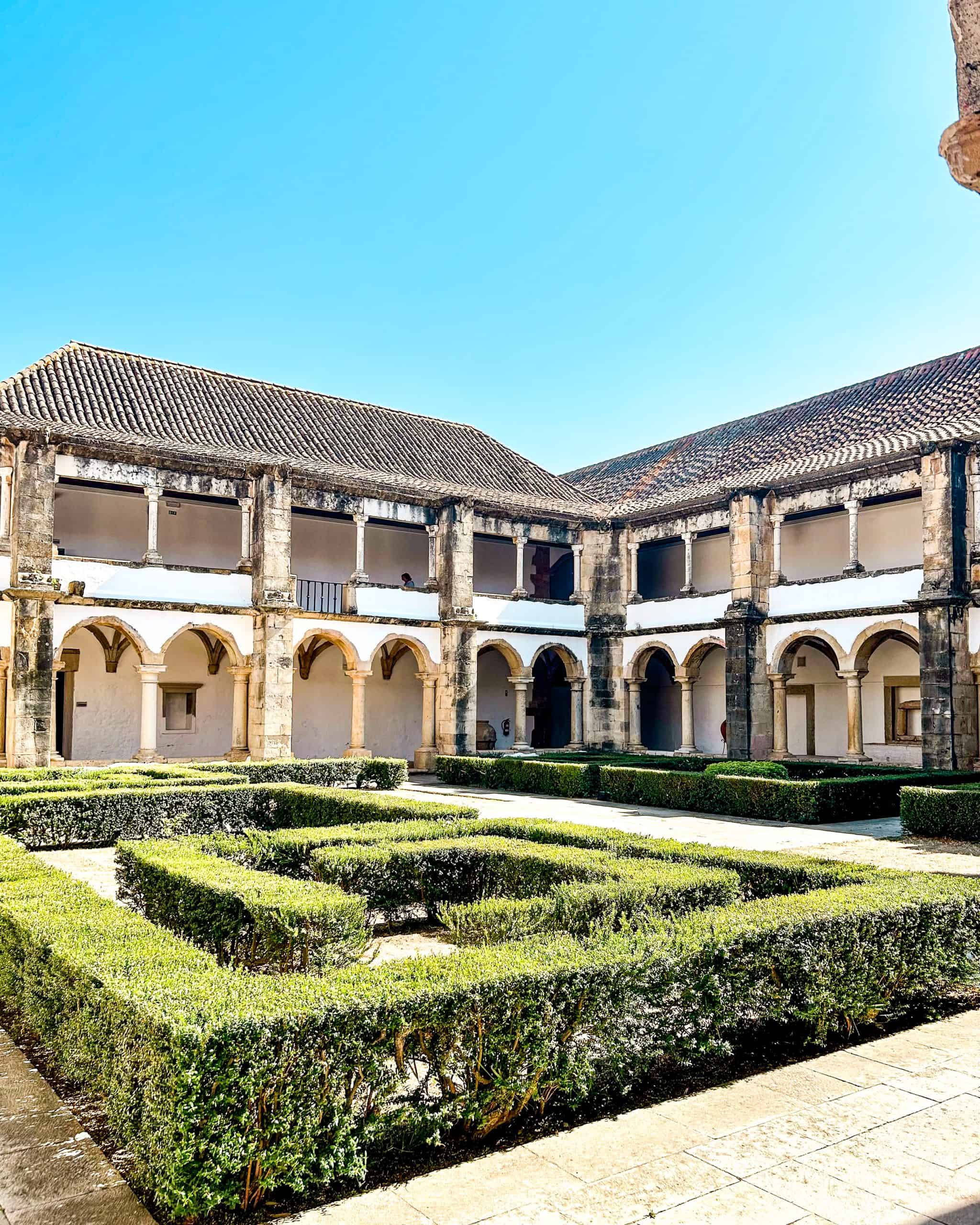 Municipal Museum in Faro, Portugal featuring a large courtyard with green bushes on a summer day