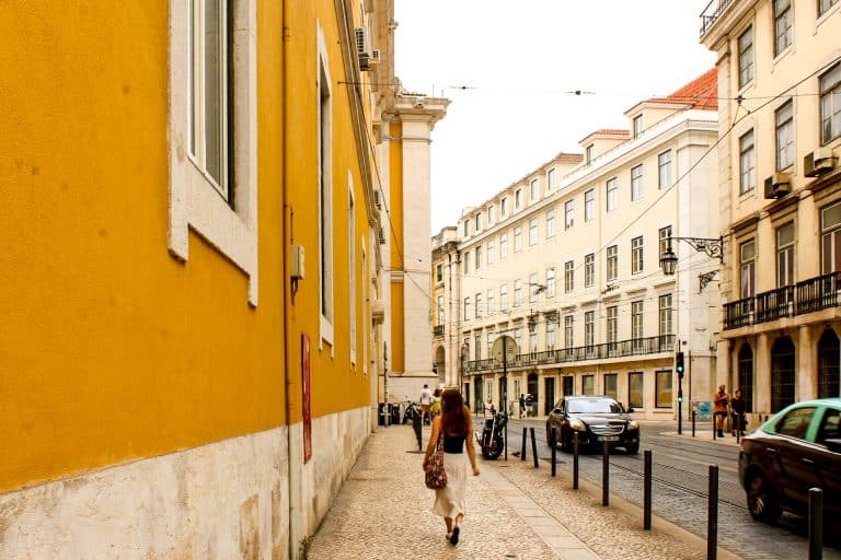 young woman walking down the street in Lisbon, Portugal