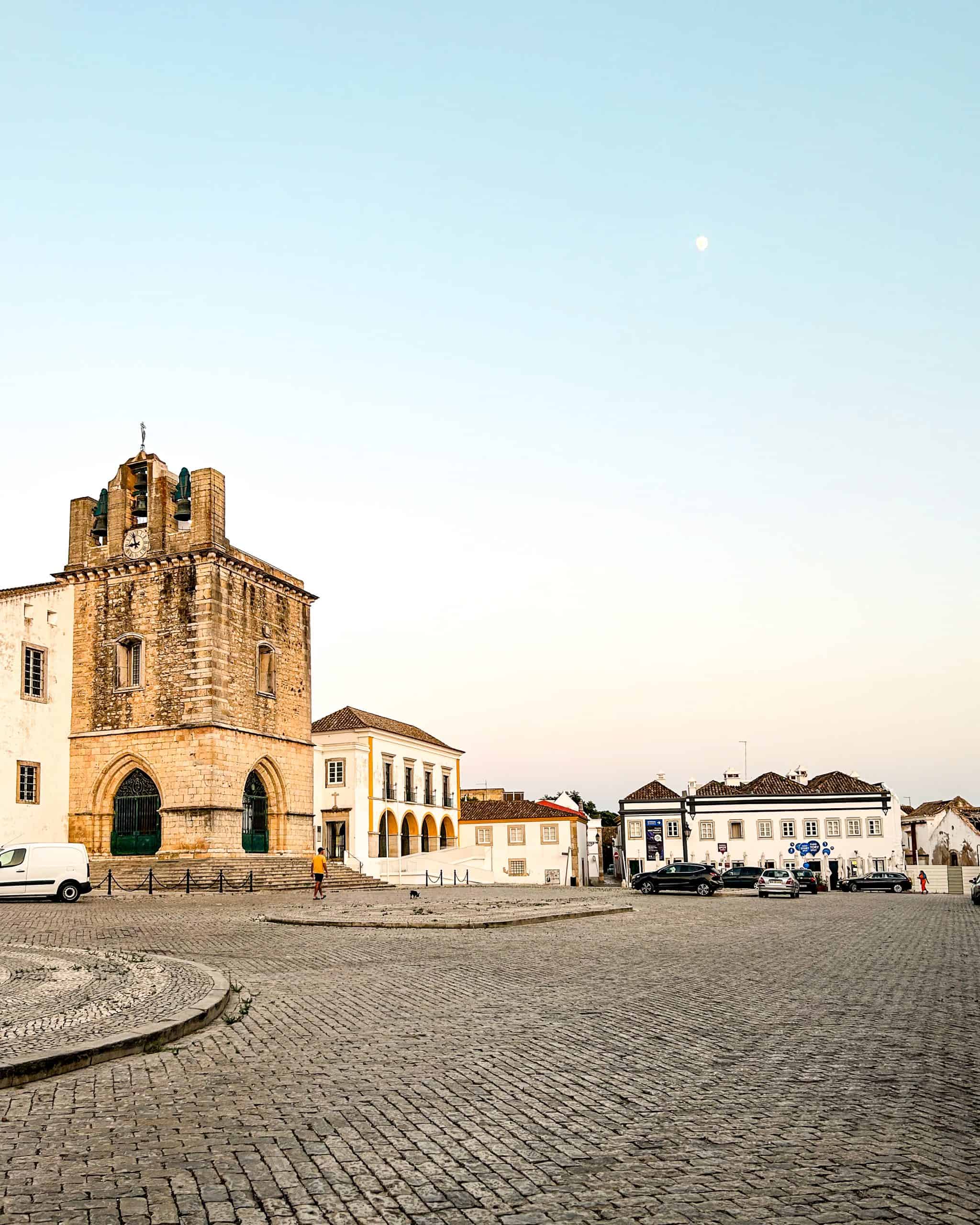 Old Town in Faro, Portugal at dusk featuring the old cathedral and cobblestone courtyard