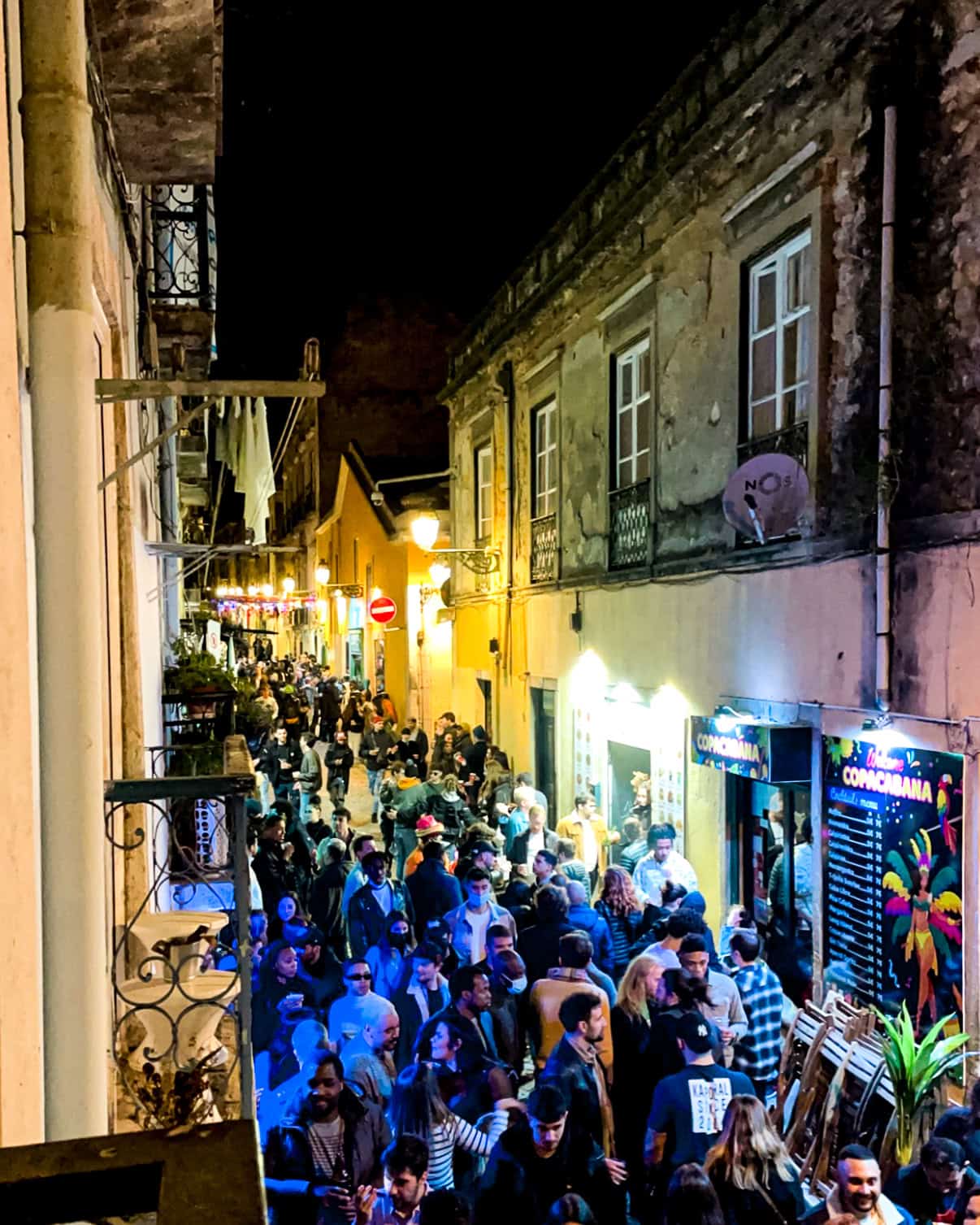 crowded, lively street in Lisbon, Portugal at night