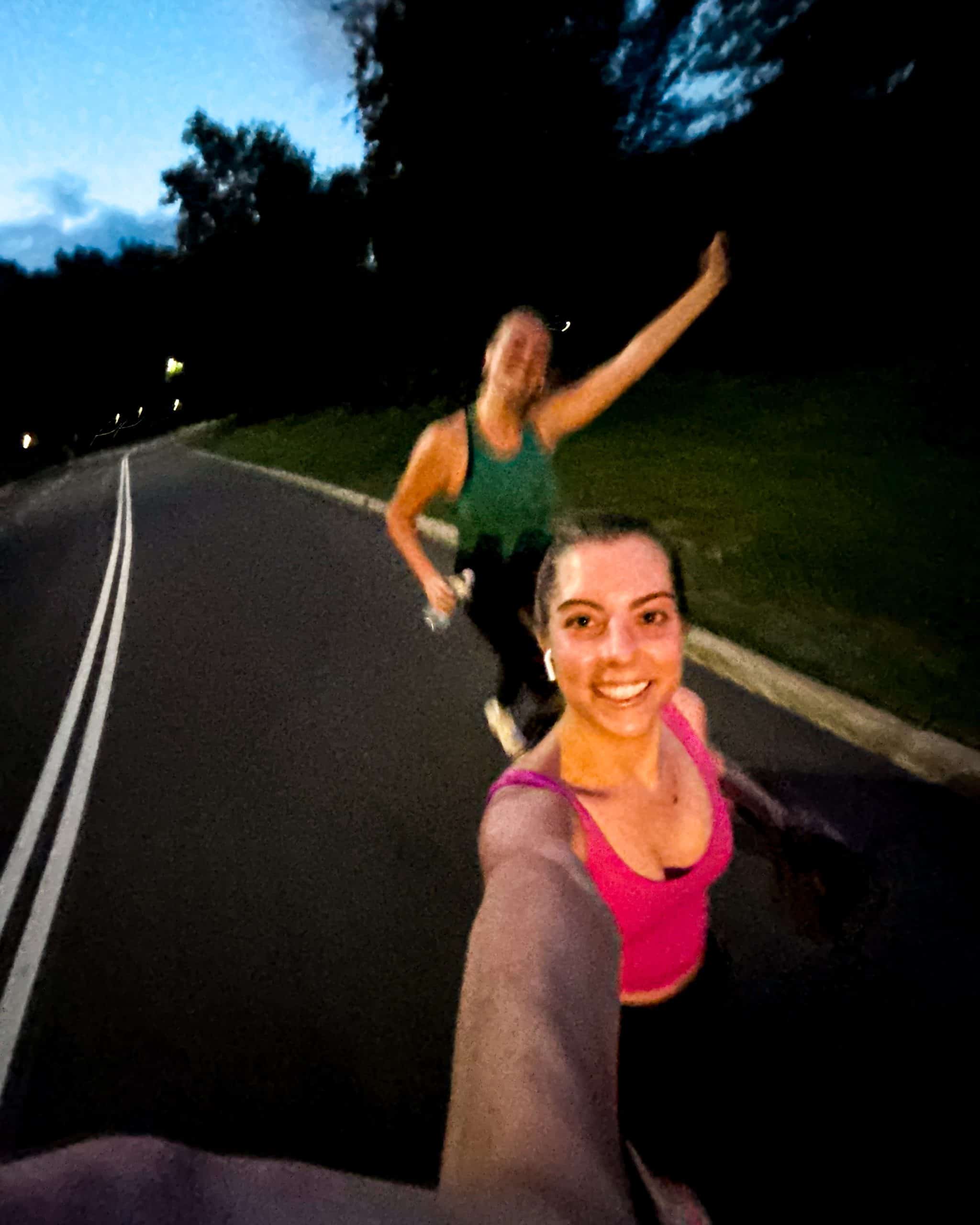 two women running in central park in NYC at night