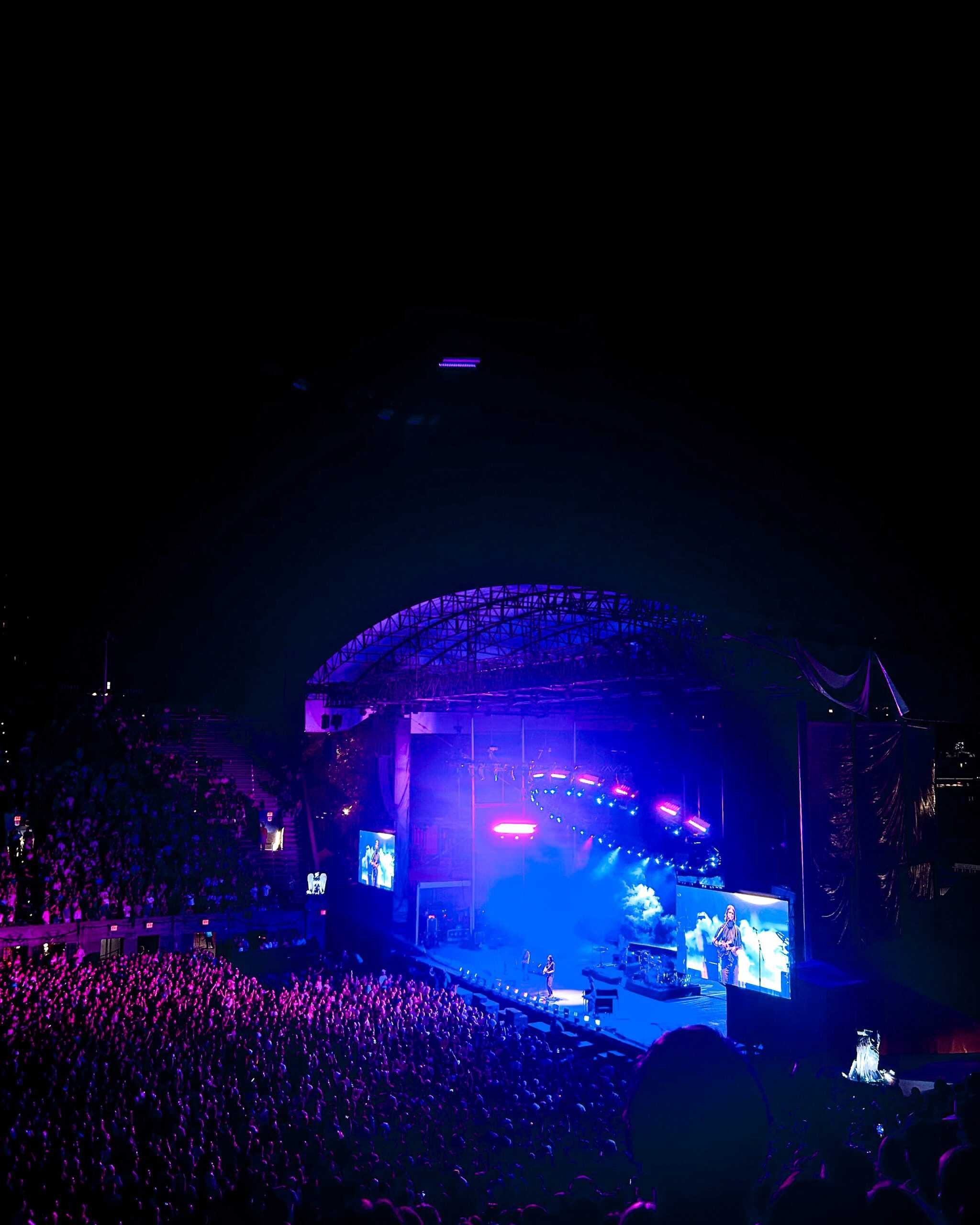 a concert with thousands of people at Forest Hills in New York City