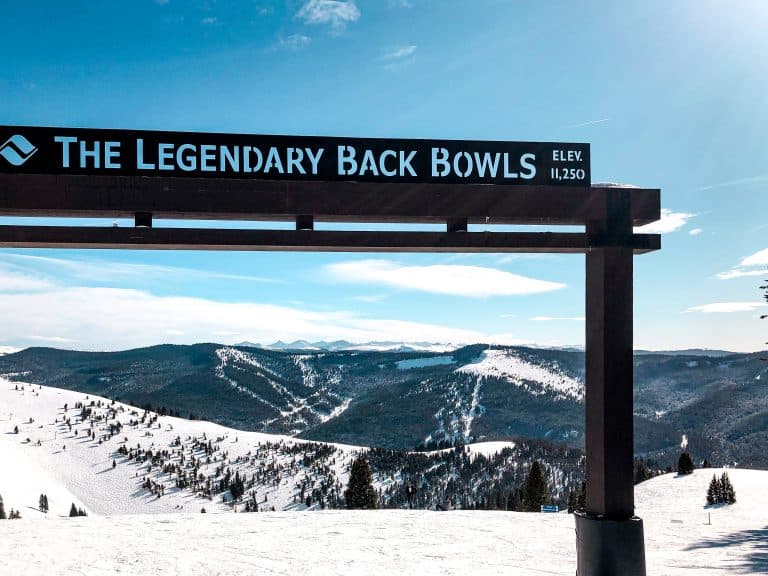 The Legendary Back Bowls sign at Vail Ski Resort with panoramic mountain views in Colorado