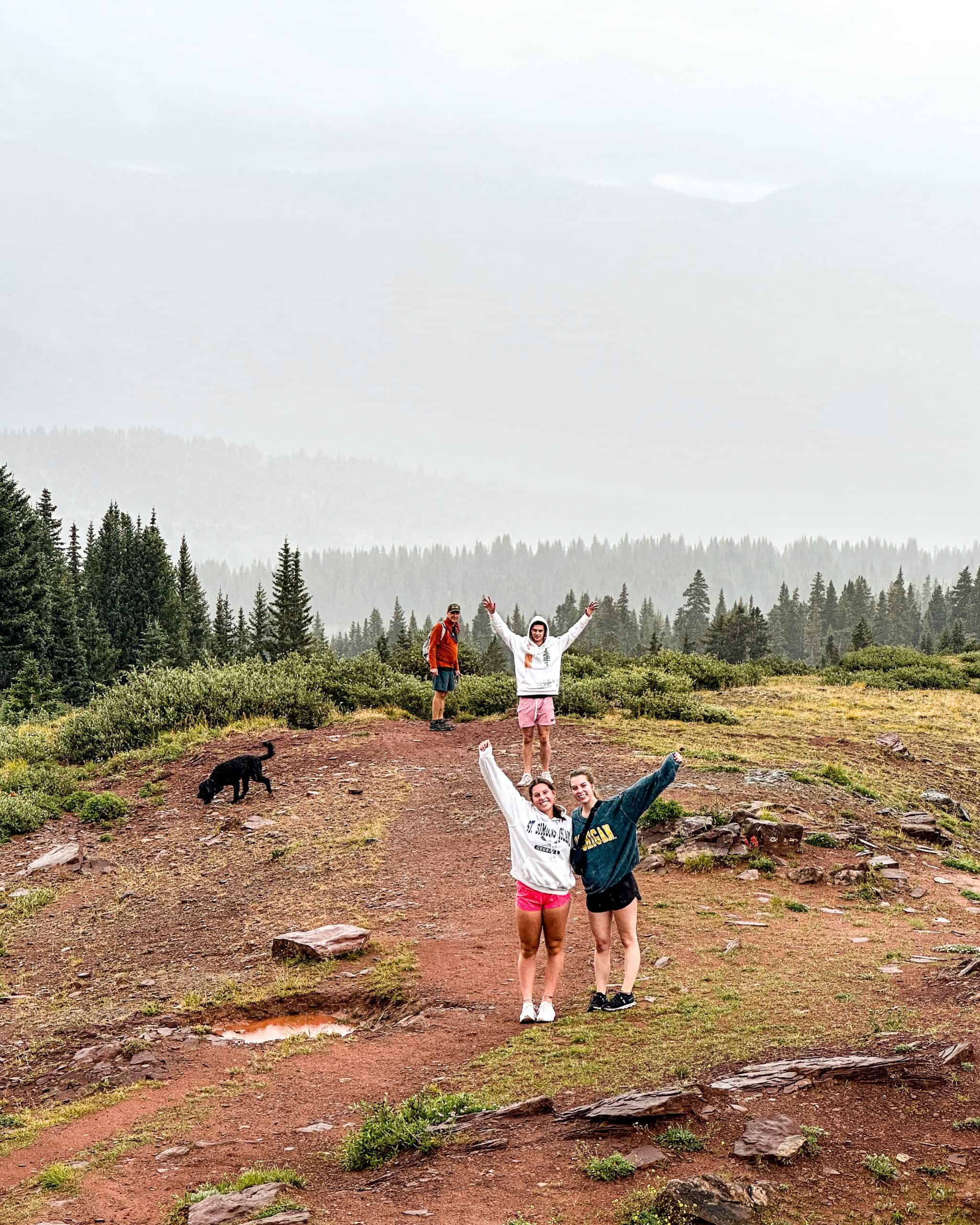 Hiking trail near Vail, Colorado with friends enjoying summer scenery 