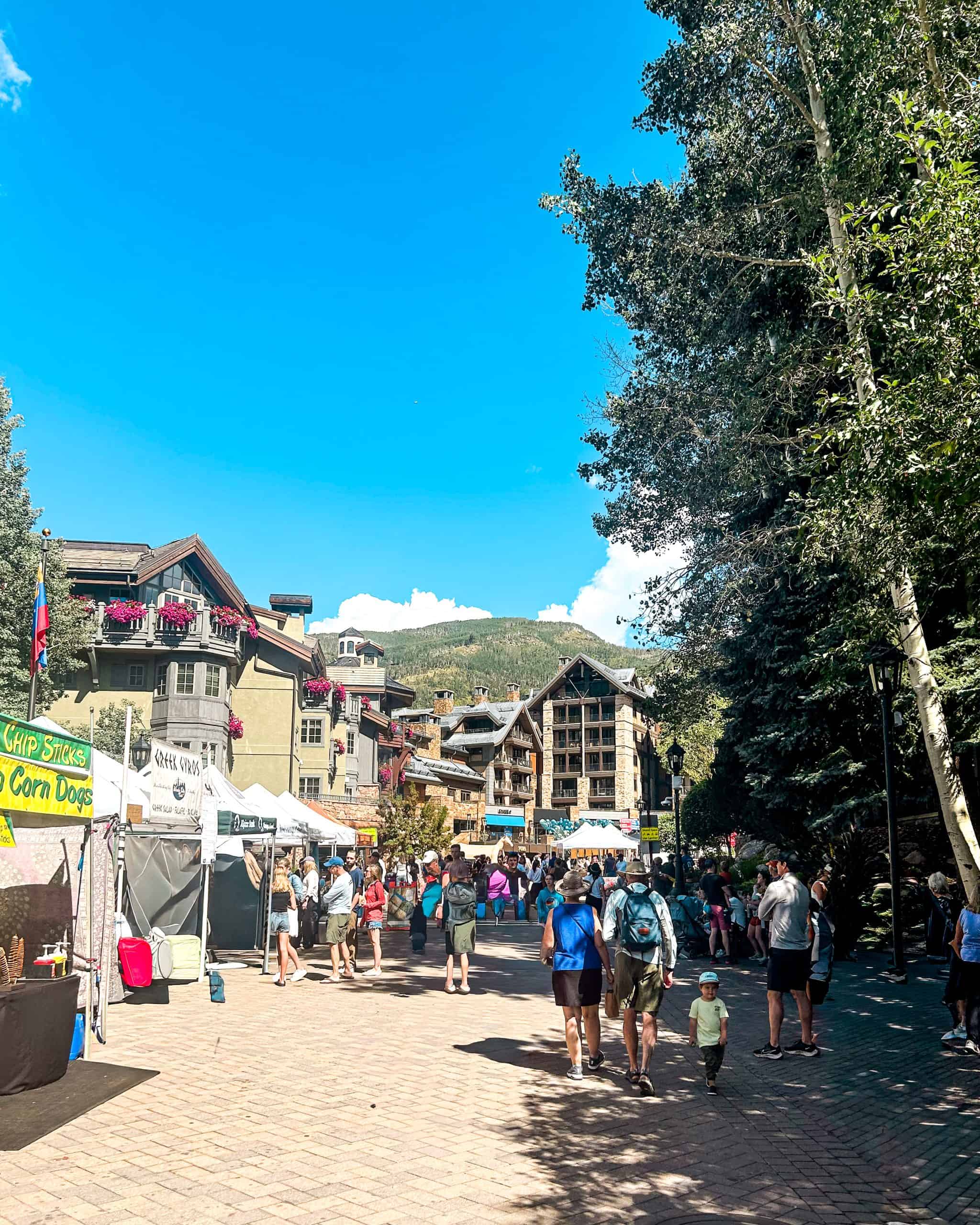 Vail Farmers Market and Art Show in Vail Village, Colorado with local vendors, summer crowds, and mountain scenery