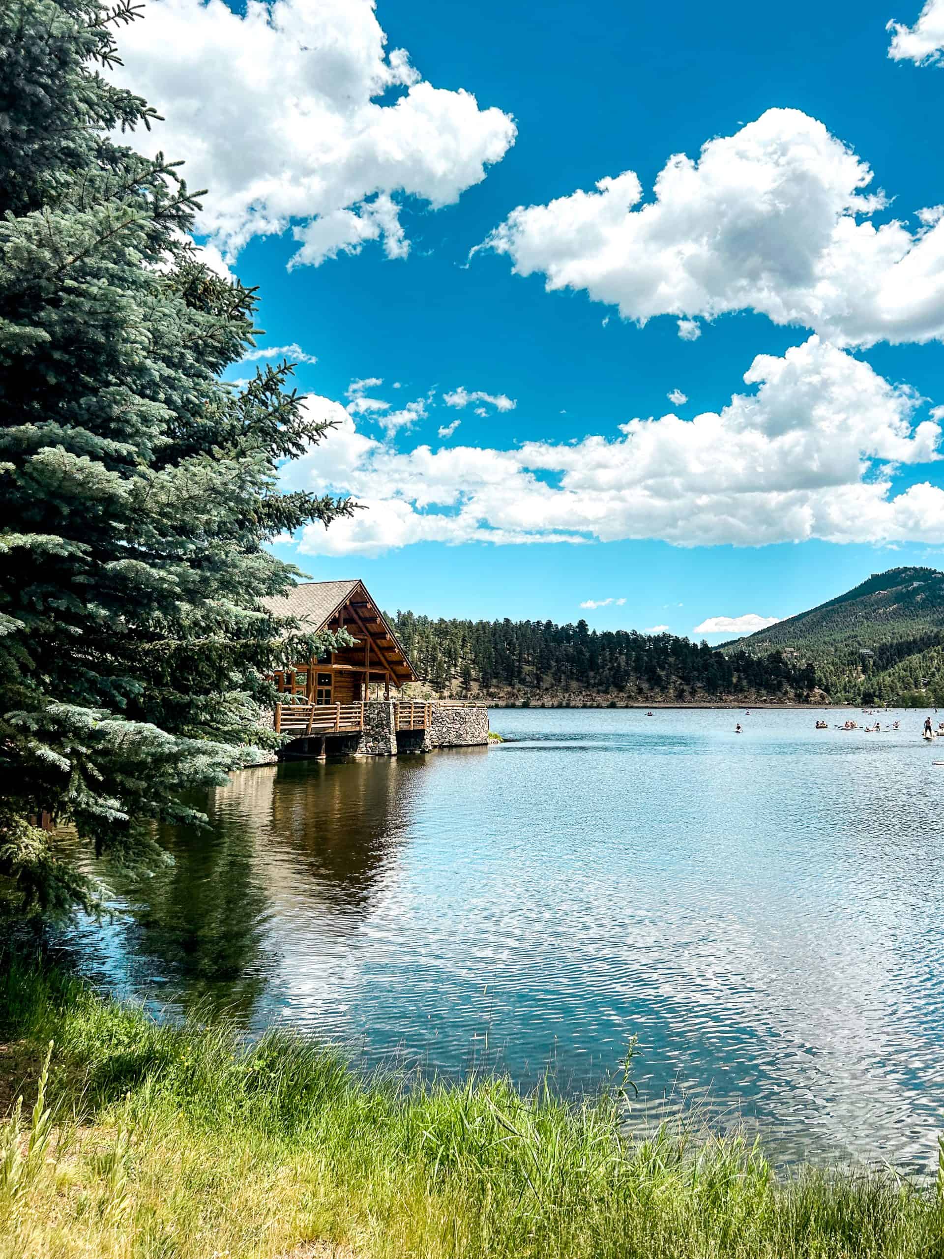 Evergreen Lake surrounded by mountains and pine trees, a peaceful mountain lake day trip from Denver.