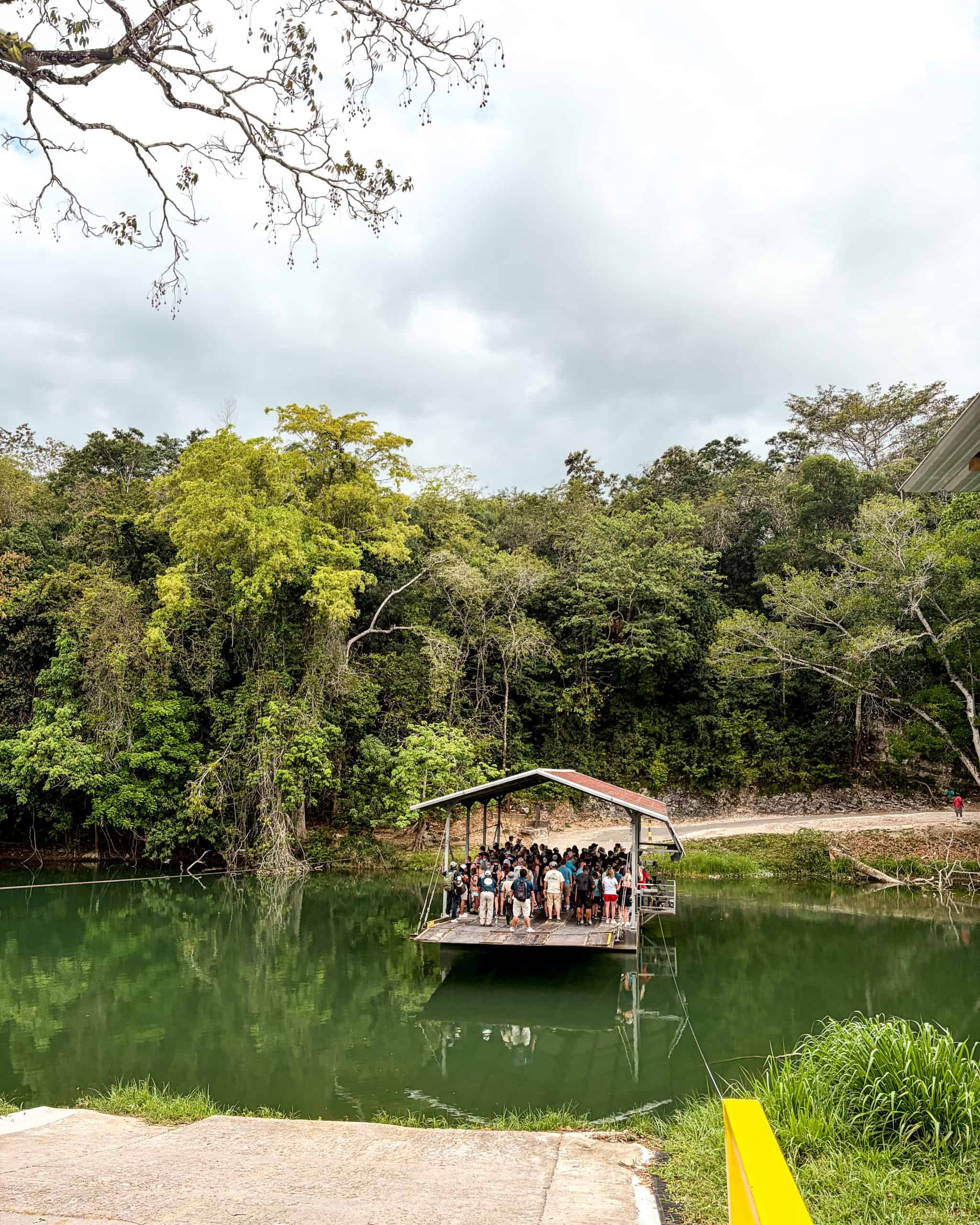 Hand-cranked ferry crossing the river to reach Xunantunich ruins in Belize