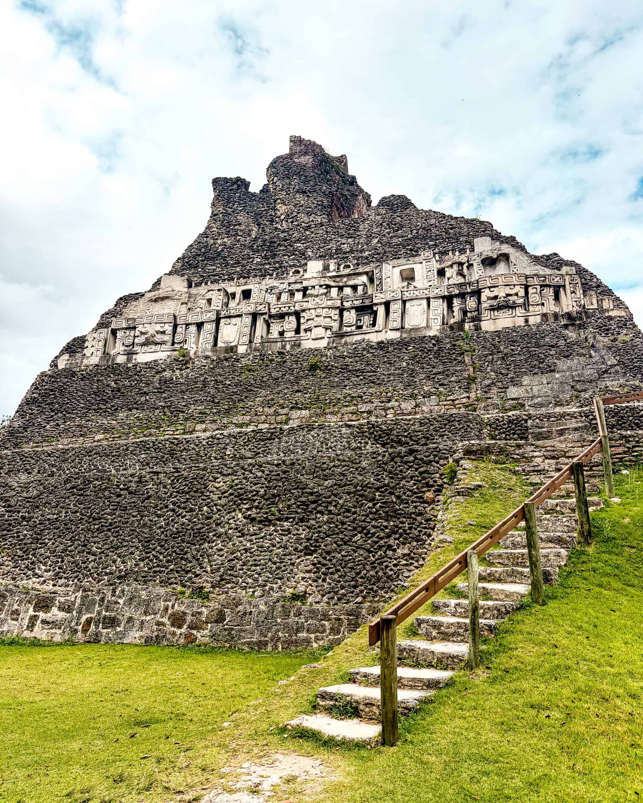 Intricate carved stone relief decorating the side of Xunantunich in Belize