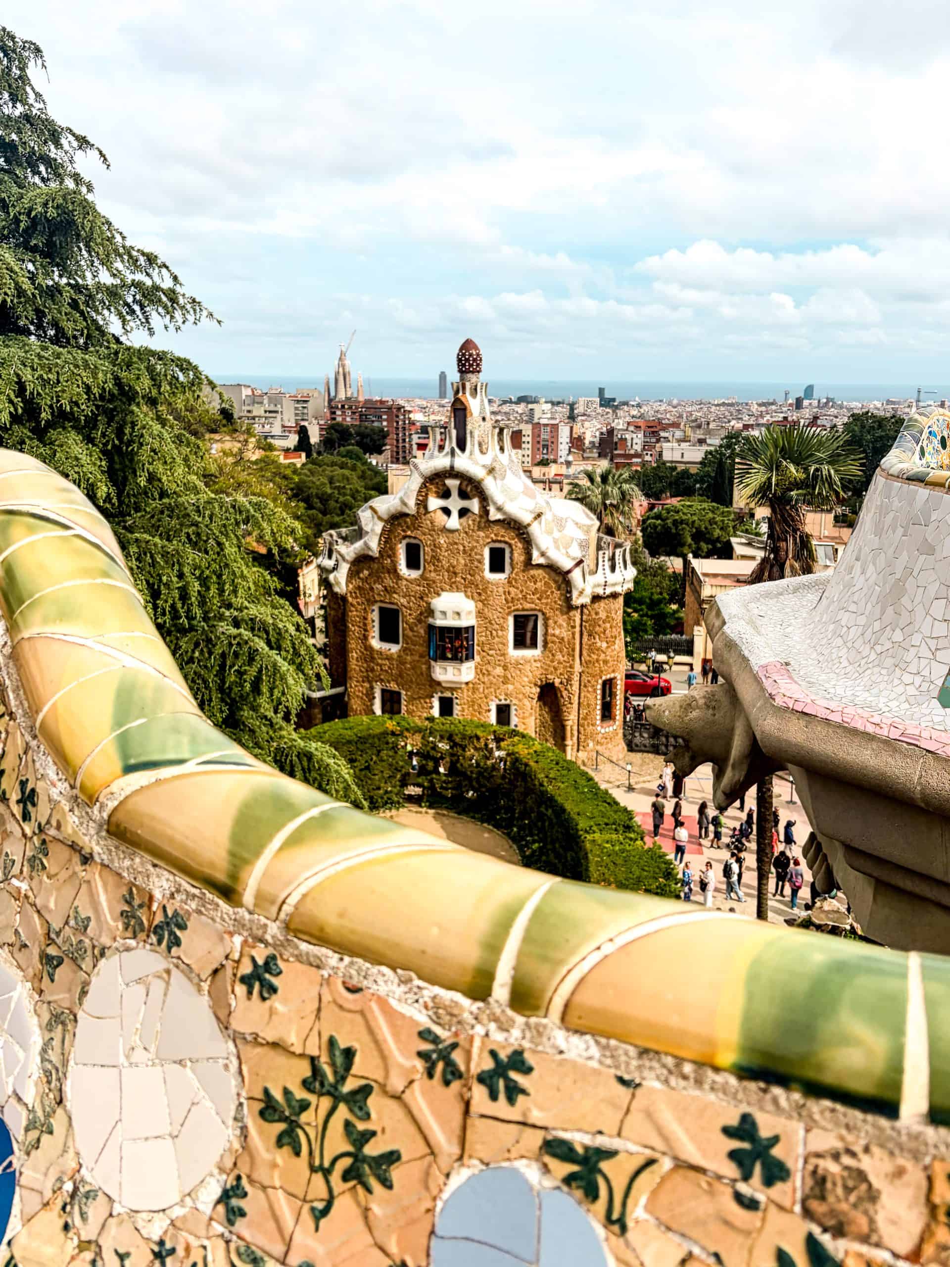Broken tile mosaics in vivid colors cover curved surfaces at Park Güell