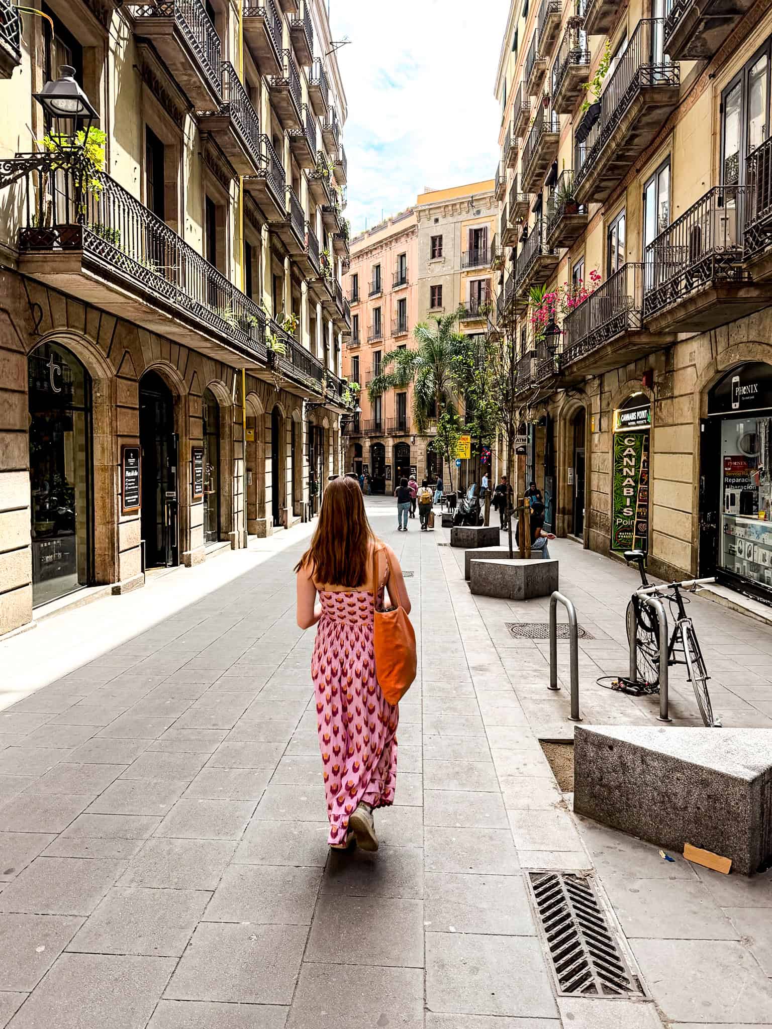 A broad Eixample boulevard lined with ornate Modernista building facades in Barcelona