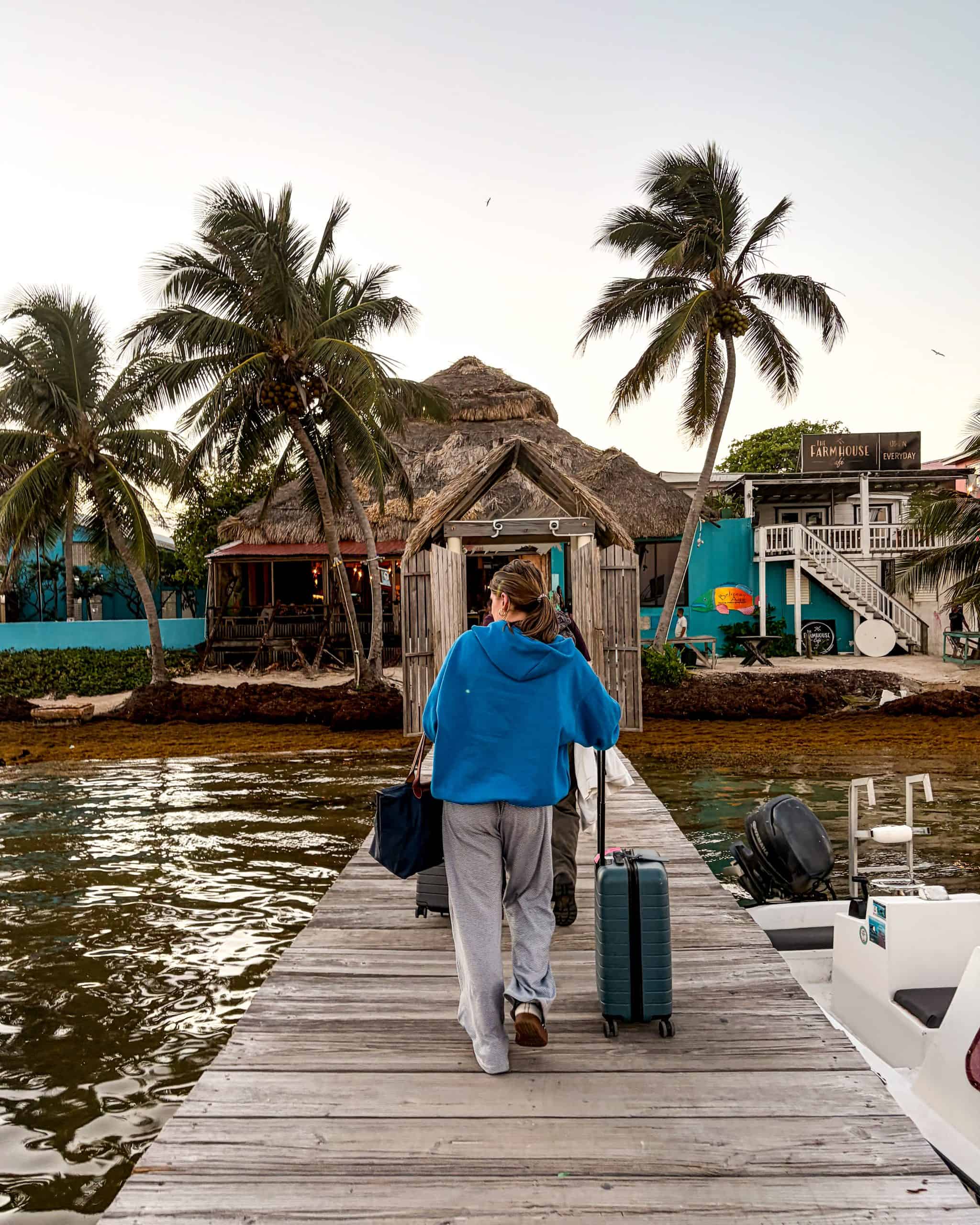 Passengers stepping off a water taxi onto the dock at Caye Caulker